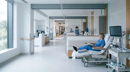 Medical professional reviewing clinical trial documentation in a modern research facility with controlled lighting